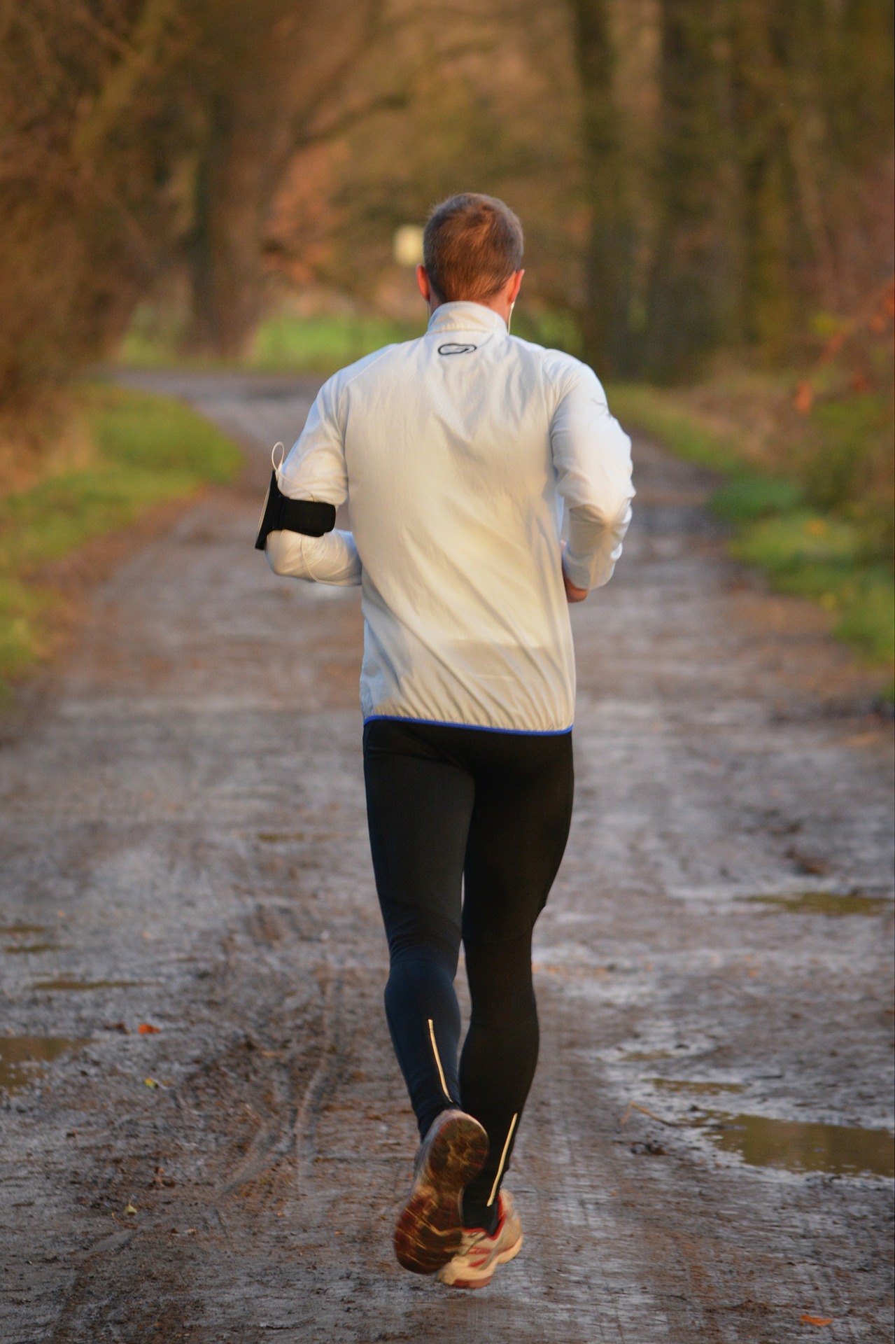 Un coureur amateur en pleine Nature avec sa ceinture cardio et son application sur smartphone